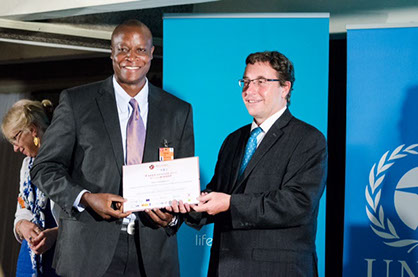 Andrew Ssentongo receiving the SEED Award certificate